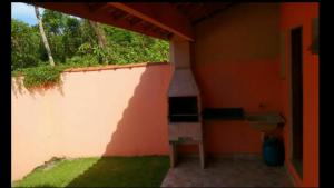a room with an orange wall and a stove at Casas em Boracéia in Boracéia
