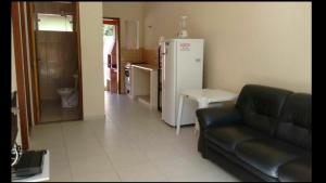 a living room with a couch and a refrigerator at Casas em Boracéia in Boracéia