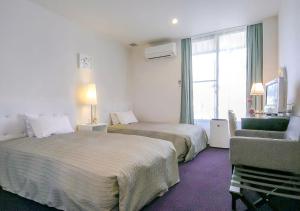 Un pat sau paturi într-o cameră la Hotel Kazusa
