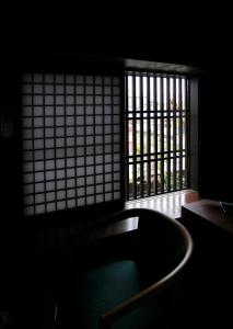 a bath tub in a room with a window at Tagoto in Aizuwakamatsu