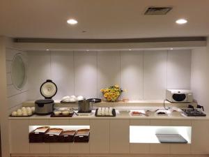 a kitchen with a counter with a clock on it at Hotel Cullinan Yongin in Yongin