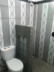 a bathroom with a toilet and a shower at Murni’s House in Lovina