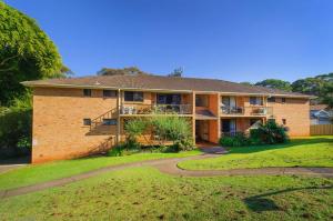 a large brick house with a yard at Shelly Cove 13 113 Pacific Drive in Port Macquarie