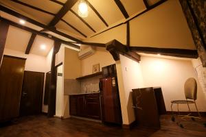 a kitchen with brown appliances and a ceiling at Hotel Heranya in Kathmandu