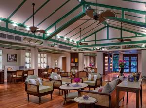 a lobby with couches tables and chairs at Dusit Thani Laguna Phuket in Bang Tao Beach