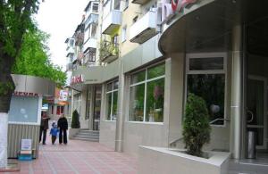 a woman and a child standing outside of a building at Центр, 2х комнатная студио возле парка, WIFI in Vinnytsya