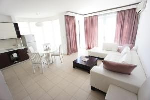 a living room with a couch and a table at Petrovac Bay Apartments in Petrovac na Moru