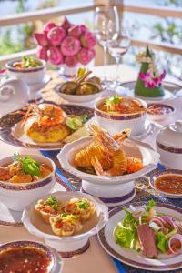 a table full of plates of food on a table at Dusit Thani Laguna Phuket in Bang Tao Beach