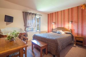 Postel nebo postele na pokoji v ubytování L'Auberge Campagnarde