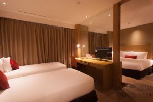 Ліжко або ліжка в номері Solaria Nishitetsu Hotel Busan