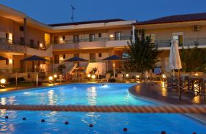 a large swimming pool in front of a hotel at Alexander Inn in Stavros