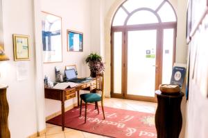 an office with a desk with a laptop on it at Li Pusciai in Cocumola