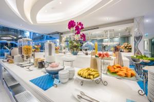 a store with fruits and vegetables on a counter at Le Tada Residence in Bangkok