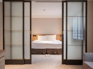 Letto o letti in una camera di Royal Inn Taipei Nanxi - MRT Zhongshan Station