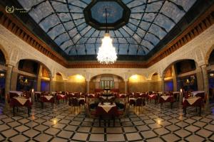 a large dining room with a chandelier in a building at Hotel Imperial Plaza & Spa in Marrakech