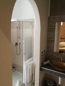 a bathroom with a shower and a sink and a tub at B&B Cascina Barolo in Turin
