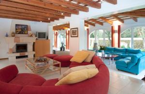 a living room with red couches and a fireplace at Sa Legitima in Ciutadella