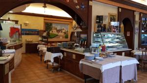 a restaurant with tables and chairs and a counter with food at Antico Casale in Turin +13 photos
