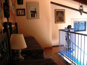 a living room with a stair railing and a lamp at Villa vista MARE a MÀKARI in San Vito lo Capo