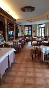 a dining room with tables and chairs and a restaurant at Antico Casale in Turin