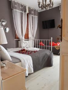 a bedroom with a bed and a tv in a room at B&B Villa Ngiolò "vista mare" in Ancona