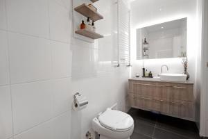 a white bathroom with a toilet and a sink at New monumental garden view Studio in Amsterdam +16 photos