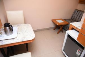 a small kitchen with a table and a chair at Grand Choice in Bangalore