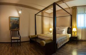 a bedroom with a canopy bed and a chair at Sala Boutique Hotel in Male City