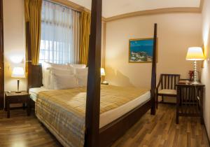 a hotel room with a bed and a window at Sala Boutique Hotel in Male City