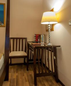 a desk with a lamp and a chair in a room at Sala Boutique Hotel in Male City