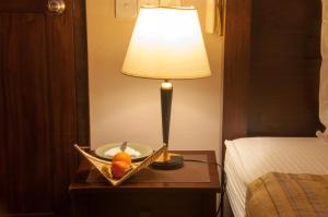 a table with a lamp and a bowl of fruit on it at Sala Boutique Hotel in Male City