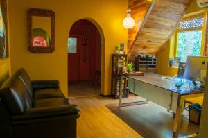 a yellow living room with a couch and a desk at Sala Boutique Hotel in Male City