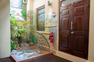 a bathroom with a door and a fish tank next to it at Sala Boutique Hotel in Male City