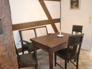 a dining room table and chairs with a candle on it at Quaint Apartment in Reddelich in Reddelich