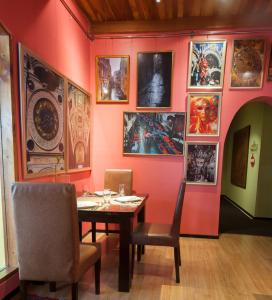 a dining room with a table and pictures on the wall at Sala Boutique Hotel in Male City
