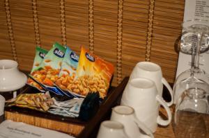 a table with a tray of chips and snacks at Sala Boutique Hotel in Male City