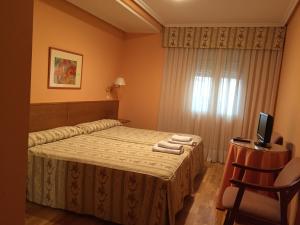 Postel nebo postele na pokoji v ubytování Hotel Benlloch