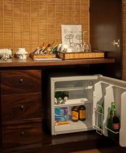 a small refrigerator with its door open in a kitchen at Sala Boutique Hotel in Male City