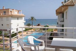 a balcony with a view of a swimming pool and the ocean at Apartamentos Talima - BTB in Denia