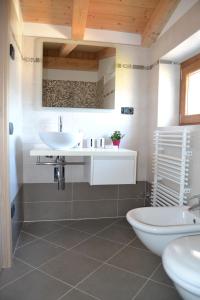 a bathroom with a white sink and a tub at Ca el Finilet in Brenzone sul Garda +9 photos