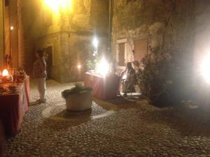 a group of people standing in an alley at night at Apartments Ban in Novi Vinodolski +68 photos