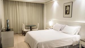 Cama ou camas em um quarto em Plaza São Rafael Hotel