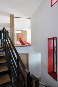 a staircase in a house with a red window at Mineral Lodge & Spa in Villaroger