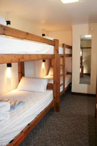 two bunk beds in a room with a mirror at Newgale Lodge in Newgale