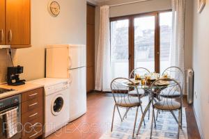 a kitchen with a table and chairs and a refrigerator at The Heart of the city in Sofia