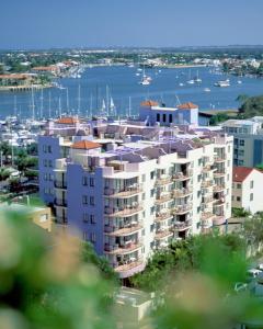 a view of a large apartment building with a marina at Nautilus Resort Mooloolaba in Mooloolaba
