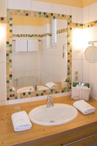 a bathroom with a sink and a mirror at Hotel Garni Landhaus Florian in Bad Blumau