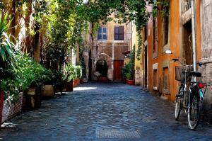 an alley with a bike parked on a cobblestone street at YH Jacuzzi Suite in Rome