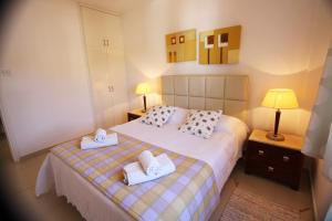 a bedroom with a bed with two towels on it at The Love Nest in Pissouri