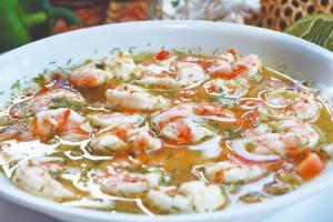 a bowl of soup with shrimp and vegetables in it at Hotel Puerto Gaviota in Tonsupa